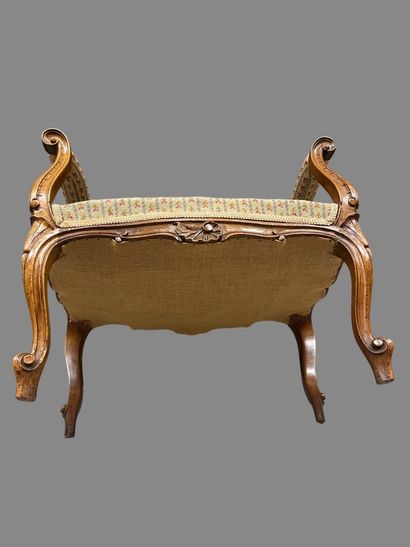 Molded and carved natural wood stool resting...