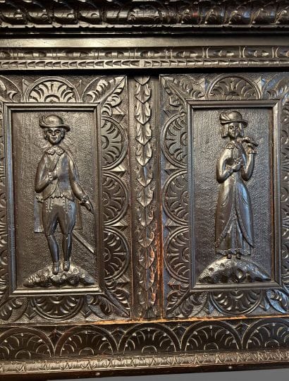 Dark patina wood cabinet with leafy moldings,...