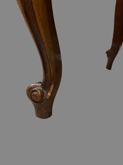 Molded and carved natural wood stool resting...
