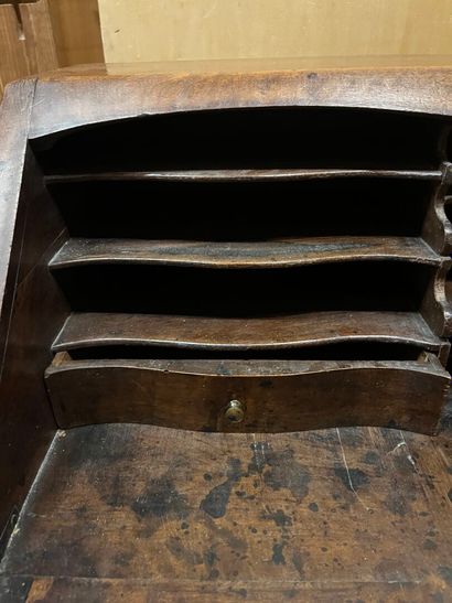 Natural wood sloping desk opening to a flap...