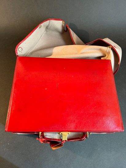 Toiletries in a suitcase in a red leather-lined...
