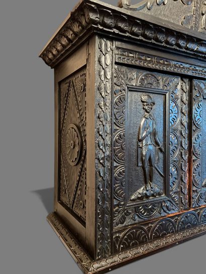 Dark patina wood cabinet with leafy moldings,...