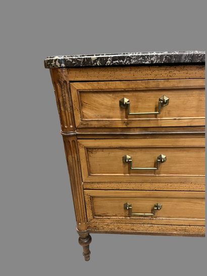 Light wood chest of drawers with three wide...