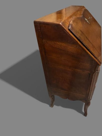 Natural wood sloping desk opening to a flap...