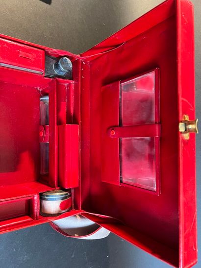 Toiletries in a suitcase in a red leather-lined...