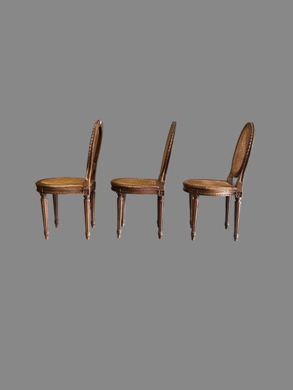 Three caned chairs in molded natural wood....