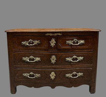 Chest of drawers in waxed oak with four molded...