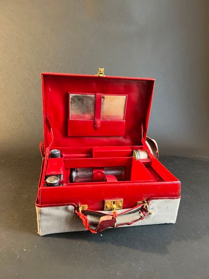 Toiletries in a suitcase in a red leather-lined...