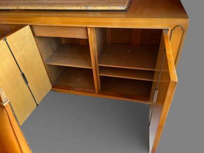 Light wood veneered sideboard opening to...