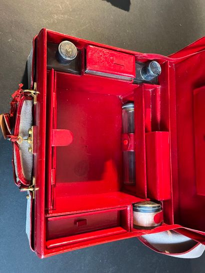 Toiletries in a suitcase in a red leather-lined...
