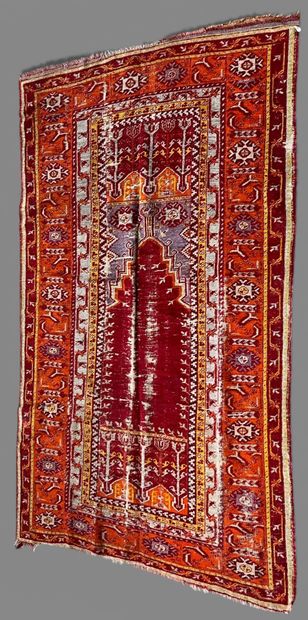 Wool carpet with Mihrab design on a red background....