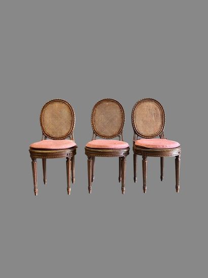 Three caned chairs in molded natural wood....