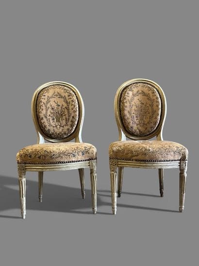Pair of chairs in cream and molded varnished...