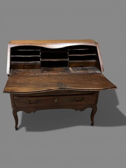 Natural wood sloping desk opening to a flap...