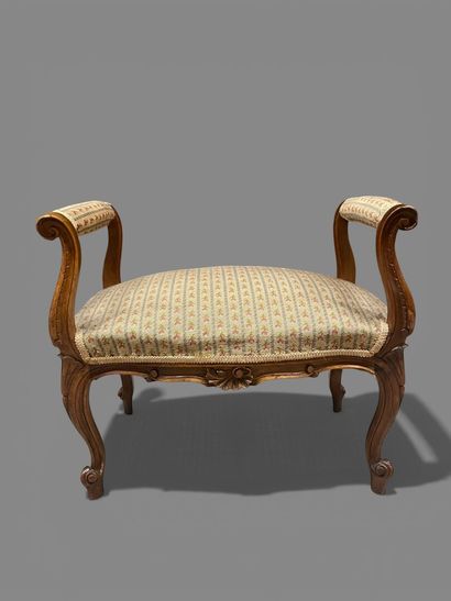 Molded and carved natural wood stool resting...