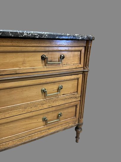 Light wood chest of drawers with three wide...