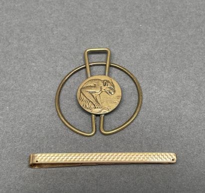 Set including a gold-plated tie clip
and...