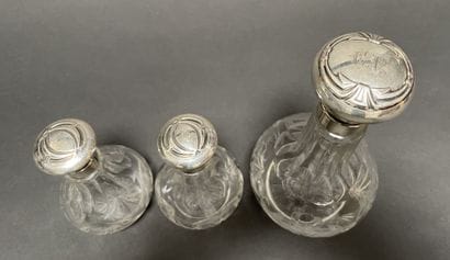 Set of three glass bottles engraved with...