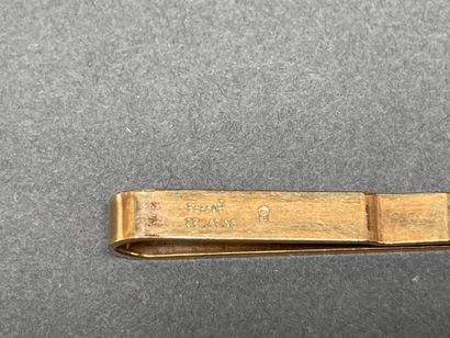 Set including a gold-plated tie clip
and...