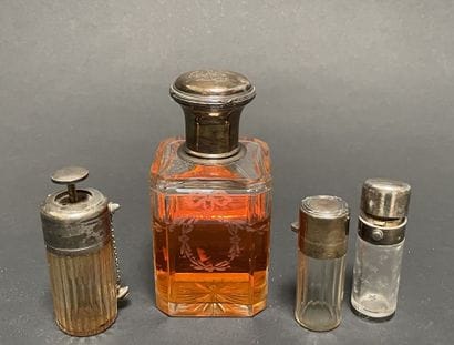 Set of four glass bottles with silver mounts...