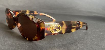 GUCCI
Pair of tortoiseshell-style sunglasses...