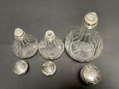 Set of three glass bottles engraved with...