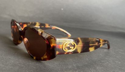 GUCCI
Pair of tortoiseshell-style sunglasses...