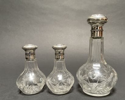 Set of three glass bottles engraved with...