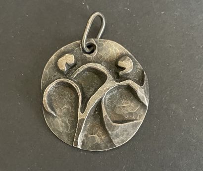 Four metal pendants, 
including “St. Francis...