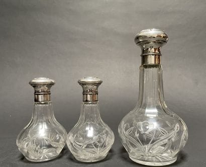 Set of three glass bottles engraved with...