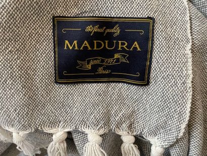 MADURA
Two plaids, one in mottled gray cotton,...