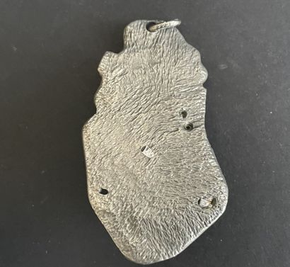 Four metal pendants, 
including “St. Francis...