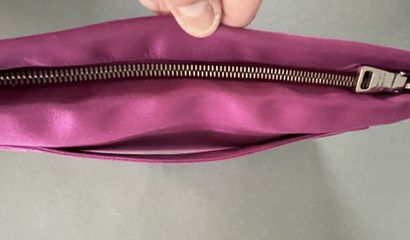 PRADA 
Burgundy satin clutch with a zipper...