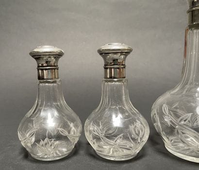 Set of three glass bottles engraved with...