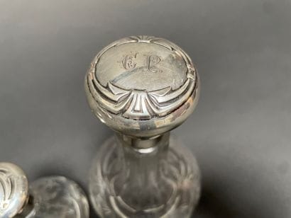 Set of three glass bottles engraved with...