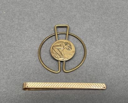 Set including a gold-plated tie clip
and...