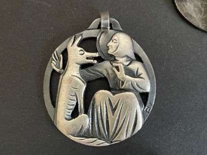 Four metal pendants, 
including “St. Francis...