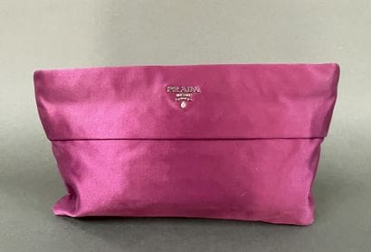 PRADA 
Burgundy satin clutch with a zipper...