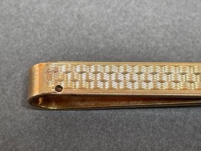 Set including a gold-plated tie clip
and...