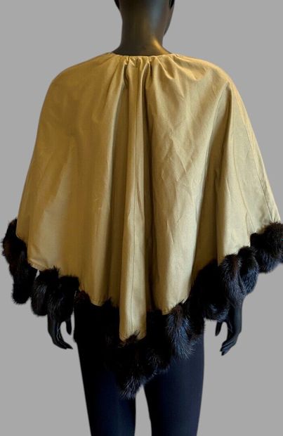 ANONYMOUS
Khaki cotton cape trimmed with...