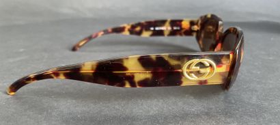GUCCI
Pair of tortoiseshell-style sunglasses...