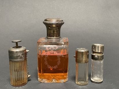 Set of four glass bottles with silver mounts...