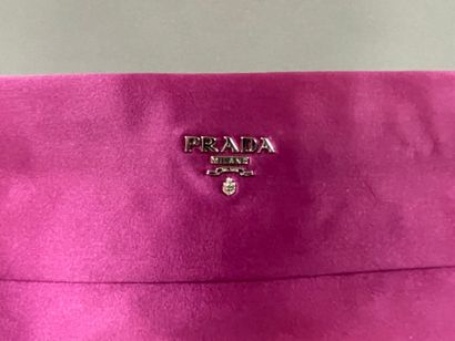 PRADA 
Burgundy satin clutch with a zipper...