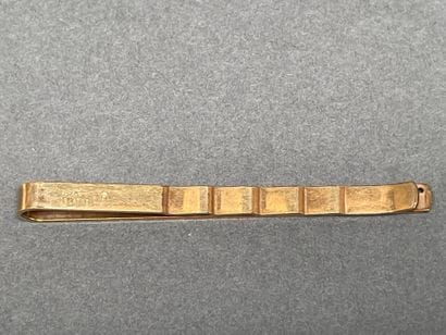 Set including a gold-plated tie clip
and...