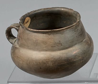Vase with two handles, presenting on the...