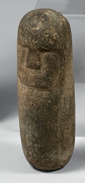A small religious totem pole with a head...