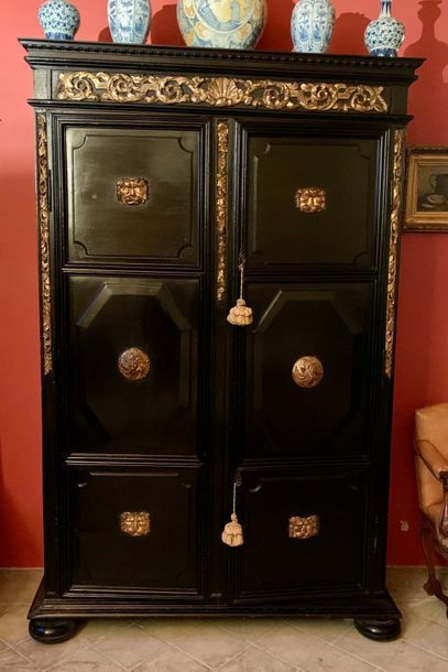 Blackened wood cabinet, the two doors with...