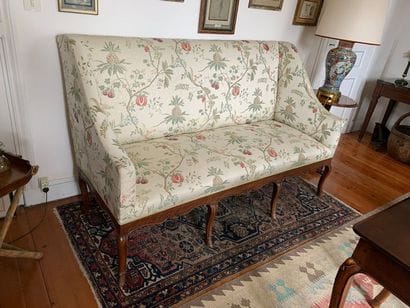 Moulded fruitwood sofa, the belt cut out...