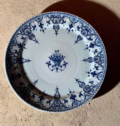 Large round earthenware dish, decorated in...