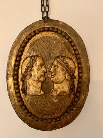 Oval medallion in gilded wood representing...